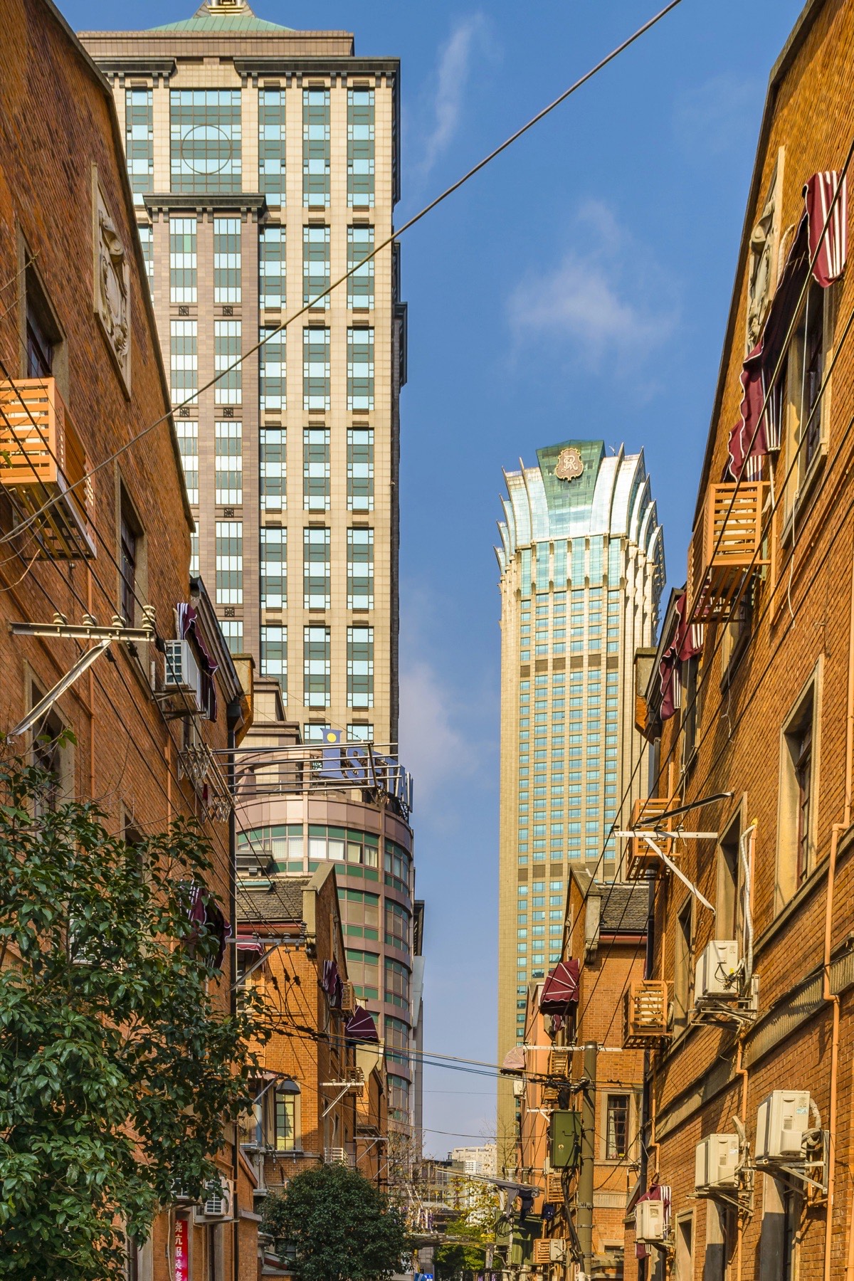 A residential lane in Shanghai with towers rising behind it